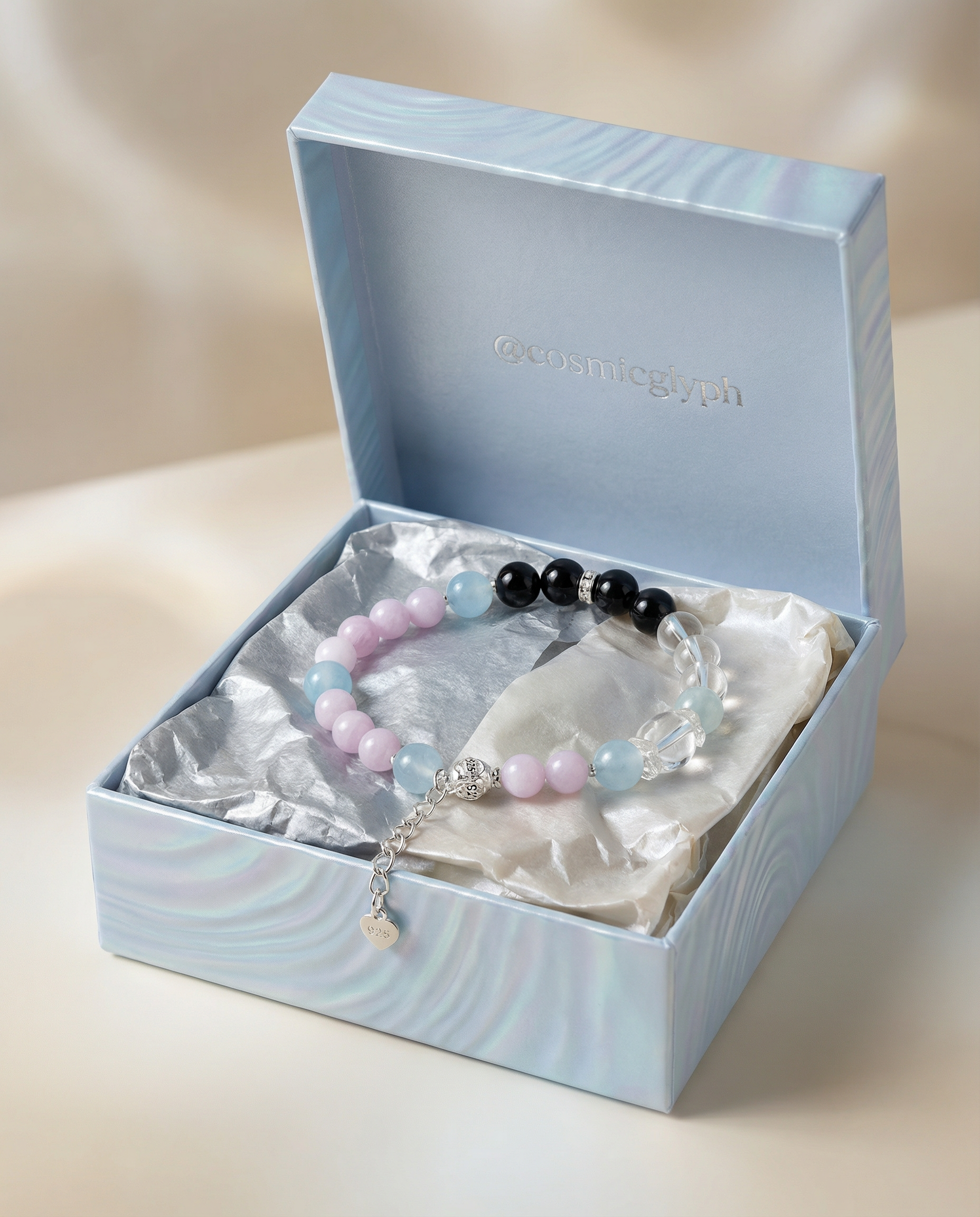 The delicate crystal bracelet presented inside a light blue gift box lined with silver and cream satin, featuring an extended chain with a sterling silver "925" heart charm.